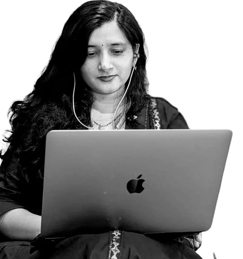 Aastha, founder of Infinite Ideations, working on her laptop